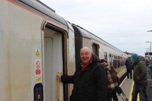 SENRUG Chair Dennis Fancett getting on a train at Bedlington Station.